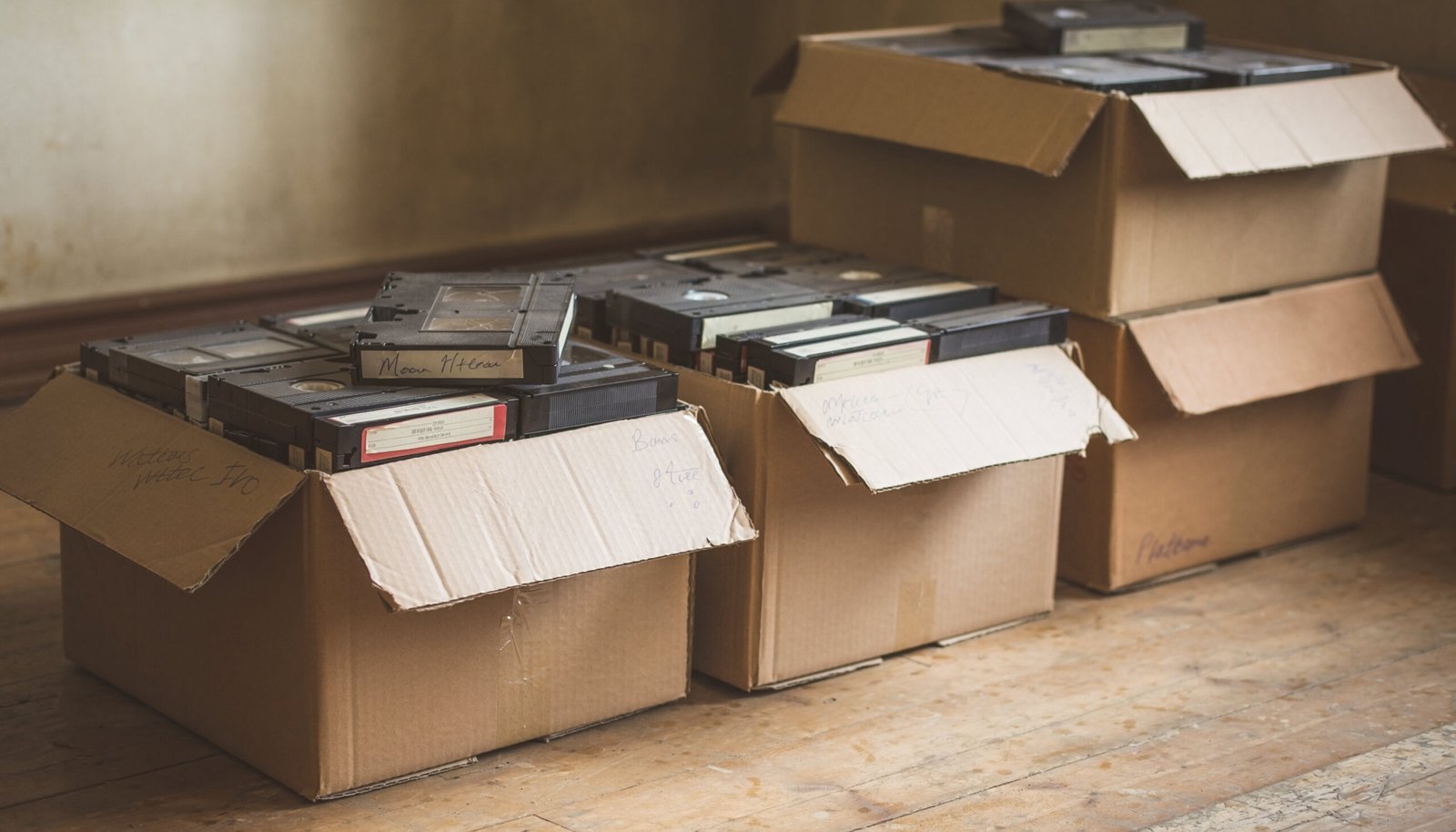 Boxes of VHS tapes prepared for professional video digitization and archival preservation by Digital Time Capsule Studios